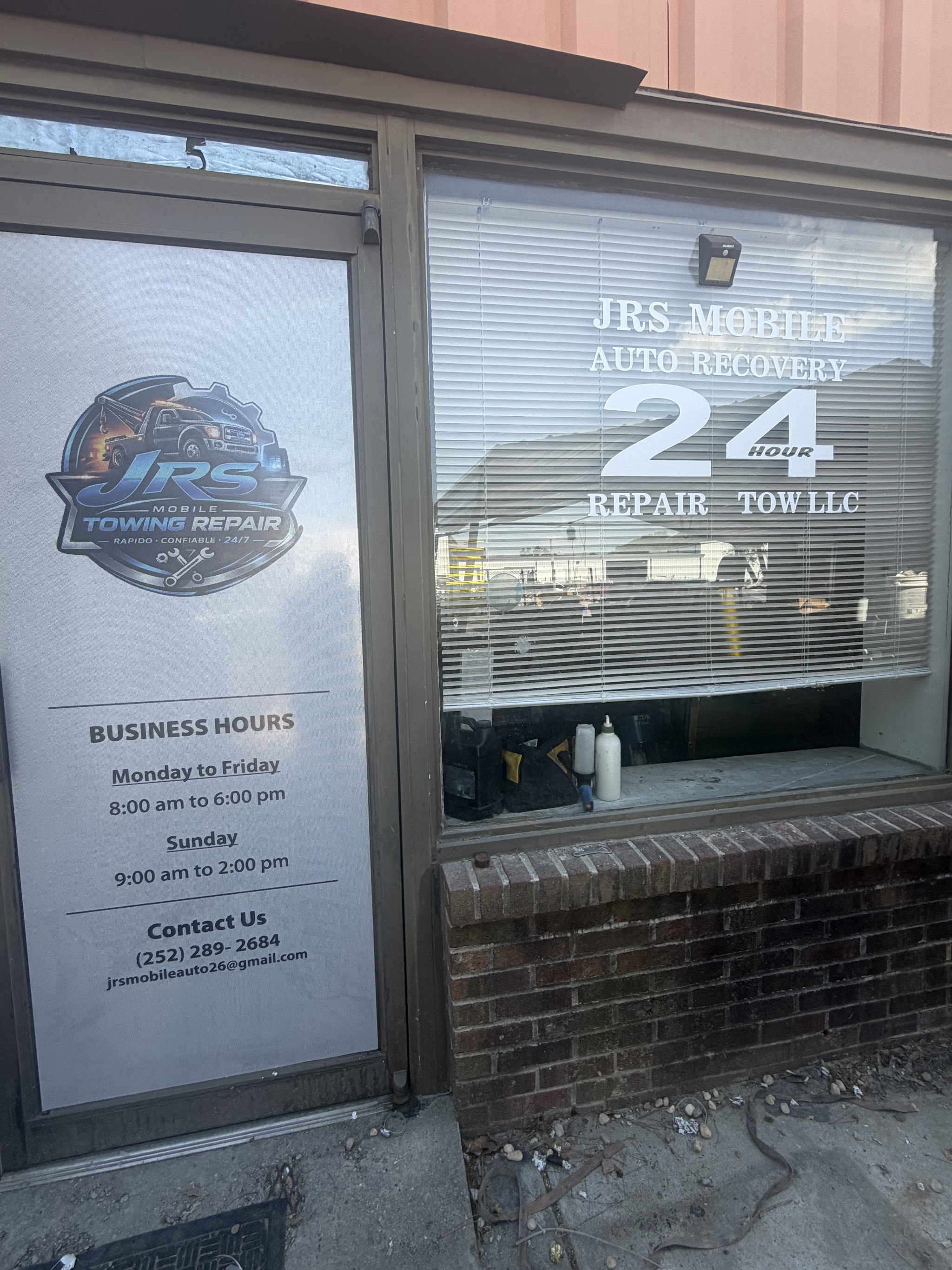 Our front door with hours and phone number